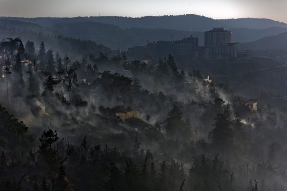 Image: A general view of Jerusalem looking down towards the the village of Ein Keren as a large fire burns in Jerusalem Forest, Israel, on June 25