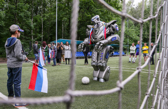 Image: Russian National soccer team supporters play soccer with Titan robot