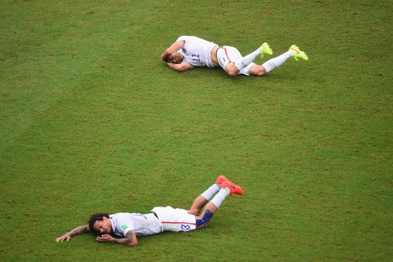 Jermaine Jones of the United States and teammate Alejandro Bedoya lie on the field after colliding during the 2014 FIFA World Cup Brazil group G match between the United States and Germany at Arena Pernambuco on June 26 in Recife, Brazil.