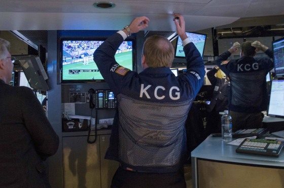 Image: Traders and workers react while watching the U.S. 2014 World Cup soccer match against Germany