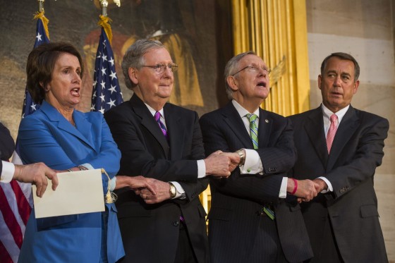 Democratic House Minority Leader from (L-R) California Nancy Pelosi, Republican Senate Minority Leader from Kentucky Mitch McConnell, Democratic Senate Majority Leader from Nevada Harry Reid, and Republican Speaker of the House from Ohio John Boehner lock hands and sing 'We Shall Overcome' during a ceremony to mark the 50th anniversary of the Civil Rights Act of 1964 in the Rotunda of the US Capitol in Washington, DC.