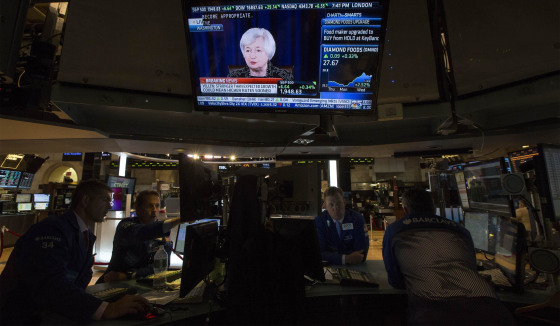 Image: Television screen displays Federal Reserve Chair Yellen's news conference as traders work on the floor of the New York Stock Exchange