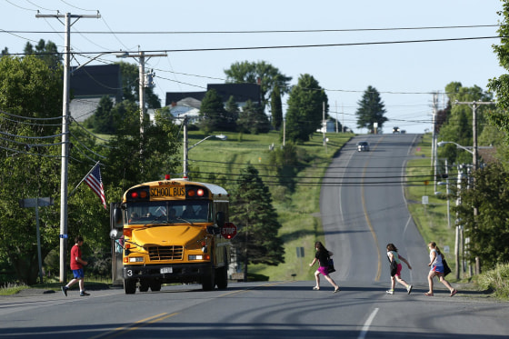 Image: Students run to school on Rte. 1 on their way to the Wellington public school in Monticello, Maine, on June 16.