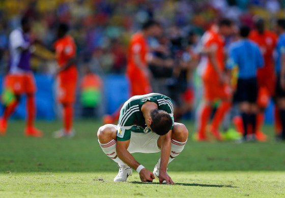 Mexico's Javier Hernandez punches the ground after the Netherlands defeated Mexico 2-1 to advance to the quarterfinals during the World Cup round of 16 soccer match between the Netherlands and Mexico at the Arena Castelao in Fortaleza, Brazil, Sunday, June 29, 2014.