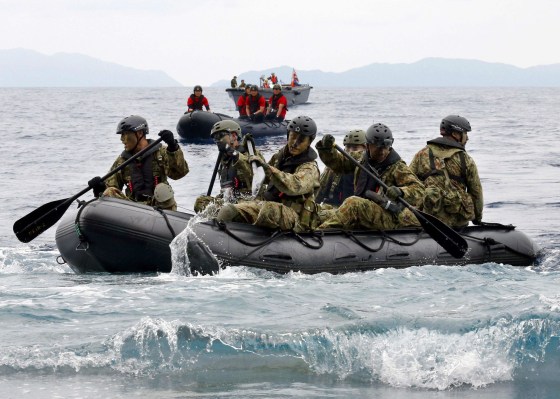 Image: JSDF soldiers approach Eniyabanare Island from JSDF transport vessel Shimokita during a military drill, off Setouchi town on the southern Japanese island of Amami Oshima