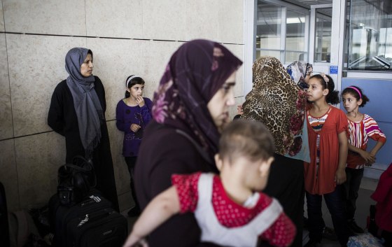 Image: Gaza residents with dual nationality passports gather at the Erez crossing