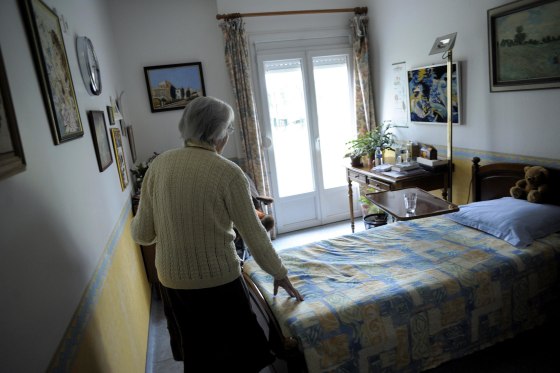 A woman, suffering from Alzheimer's desease, walks in her room on in a retirement house in Angervilliers, eastern France. 