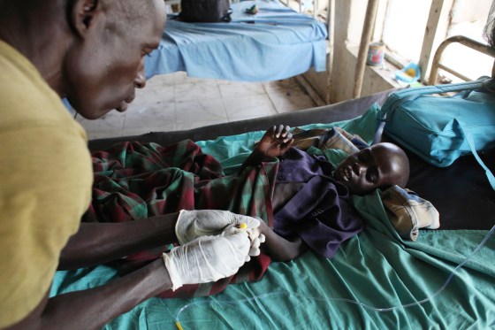 Image: An UPDF medic takes care of a malnourished child with malaria