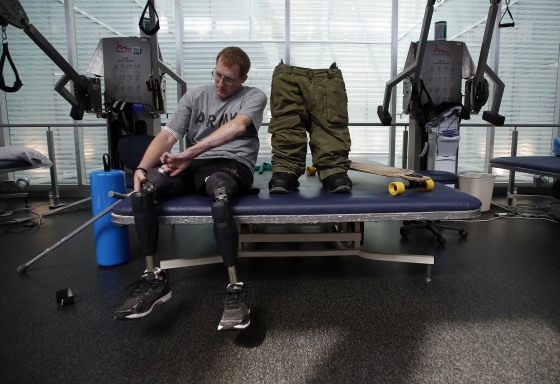 Image: Sgt. Matt Krumwiede prepares to put on prosthetic legs at Brooke Army Medical Center in San Antonio