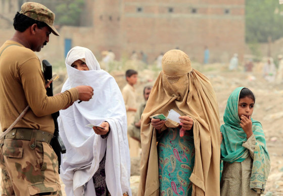 Internally displaced women beg a soldier to allow them to enter a food distribution centre set up in a sports stadium in Bannu, in northwest Pakistan July 25. Thousands of women displaced by fighting in Pakistan are struggling to get food and other aid because they lack identity cards and conservative Muslim elders have forbidden them from going to distribution centres.