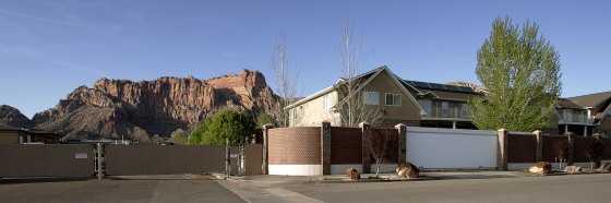 Image: Tall walls, fences and \"no access\" signs surrounds the homes of Warren Jeffs on April 20, 2006 in Hildale, Utah.