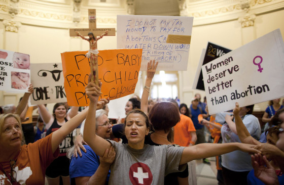 Image: Anti-abortion rights supporter Katherine Aguilar holds a crucifix and prays