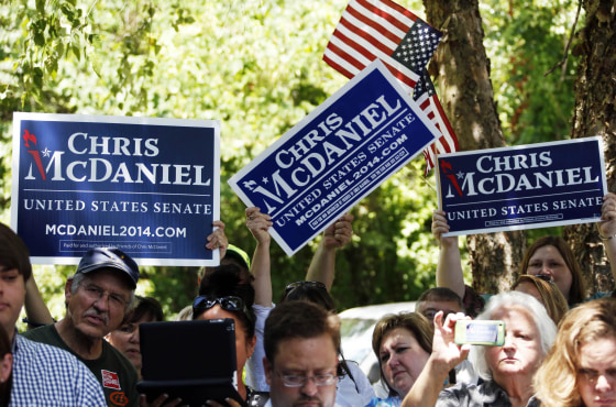 Supporters of state Sen. Chris McDaniel of Ellisville, Miss., who sought to unseat the incumbent U.S. Sen. Thad Cochran in the Republican primary, wave their signs and flags during a news conference by his attorneys and advisers in Jackson, Miss., Wednesday, July 16, 2014. Lawyers for tea party candidate McDaniel said that they intend, in the next 10 days, to file a challenge of McDaniel's loss to six-term Sen. Thad Cochran in the Mississippi Republican primary. Certified results of the June 24 runoff show Cochran won by 7,667 votes. 