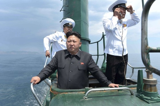 Image: North Korean leader Kim Jong Un stands on the conning tower of a submarine during his inspection of the KPA Naval Unit 167