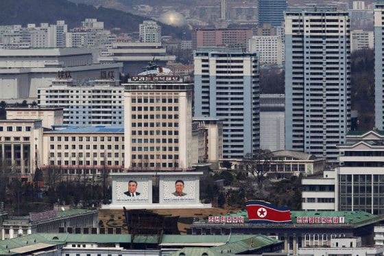 Image: File photo shows the current mosaic portrait of the founder of North Korea Kim Il-sung and the new portrait of late leader Kim Jong-il being seen in downtown Pyongyang
