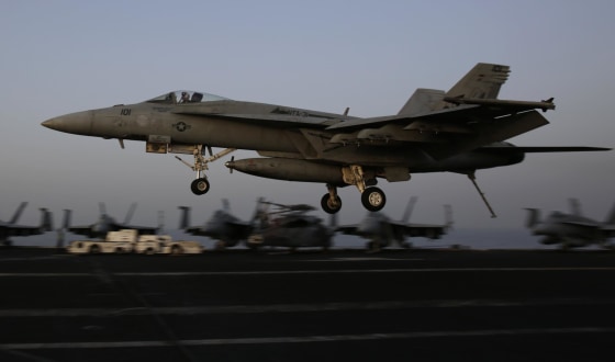 Image: An F/A-18C Hornet coming from Iraq lands on the flight deck of the U.S. Navy aircraft