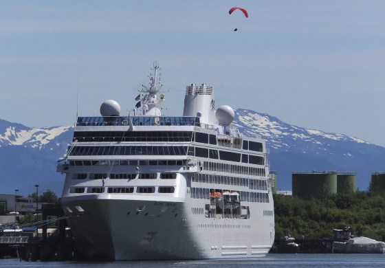 Image: A paraglider descends near a cruise ship docked in downtown Juneau, Alaska, on June 26, 2014.