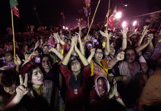 Image: Supporters of Imran Khan, cricketer-turned-opposition politician and chairman of the Pakistan Tehreek-e-Insaf political party, react while listening during the Freedom March in Islamabad