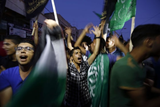 Image: Palestinians gather in the streets of Gaza City on Aug. 26, to celebrate the long-term truce agreed between Israel and the Palestinians