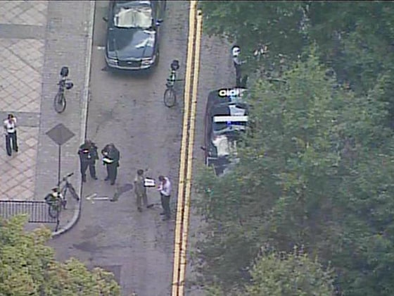 Image: Investigators on the scene at Woodruff Park in Atlanta where an officer shot a man with a knife.