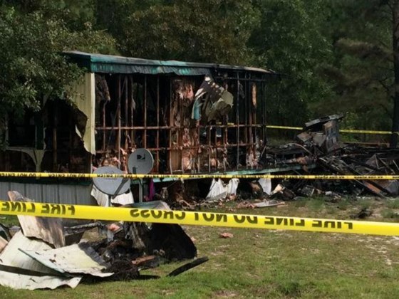 The wreckage of a mobile home that caught fire in Garland, N.C., Saturday, Aug. 8. Firefighters found the bodies of six people that apparently died in the blaze.