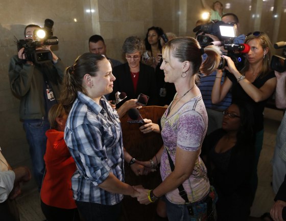 Image: Jill Winkler, left, and Pamela Dietzler hold hands as they are married at the Milwaukee County Courthouse