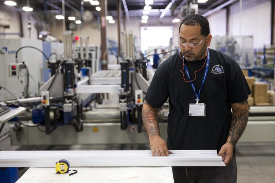 File photo, Aug. 7, 2014. A worker assembles construction supplies at Northeast Building Products in Philadelphia. 