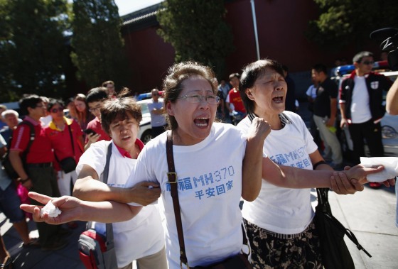 Family members of passengers on Malaysia Airlines Flight MH370 cry as they gather to pray at Yonghegong Lama Temple in Beijing September 8, 2014, on the six-month anniversary of the disappearance of the plane.