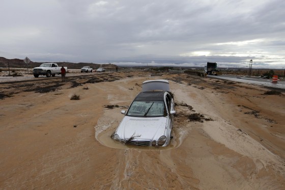 Image: A car is partially buried in mud