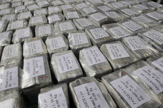 Packages containing seized cocaine are put on display after their arrival at the police airport in Lima September 1, 2014. Peruvian police seized a record 7.6 tons of cocaine in a quiet coastal town last week, arresting seven Peruvians and two Mexicans suspected of trying to smuggle the load to Europe as coal, according to Peru's Interior Ministry. 