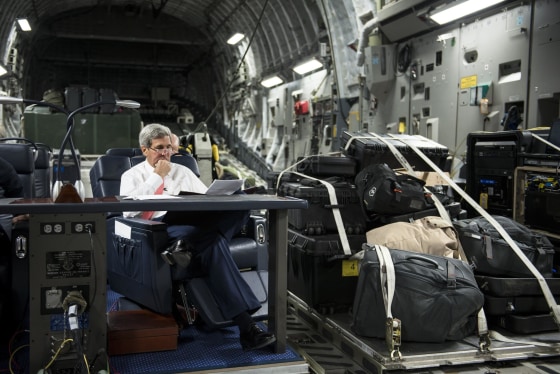 Image: U.S. Secretary of State John Kerry looks over papers while flying from Jordan to Iraq