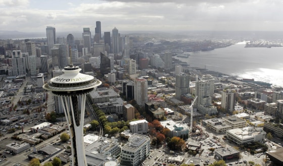 Letters 18-feet tall proclaiming Seattle's newest tourism slogan, "metronatural," are seen atop the landmark Space Needle Friday, Oct. 20, 2006, just north of downtown Seattle. The new tagline was unveiled earlier in the day by the Seattle Convention and Visitors Bureau to promote the city.
