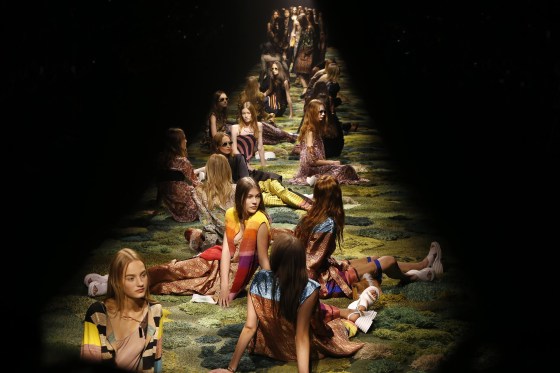 Image: Models sit on the catwalk during Dries van Noten's Spring/Summer 2015 ready-to-wear fashion collection