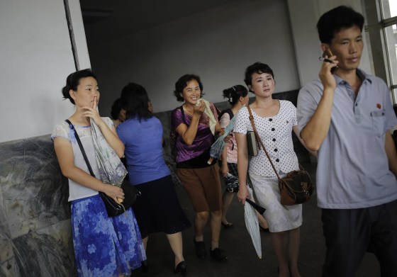 Image: North Koreans leave an underground subway station in Pyongyang,
