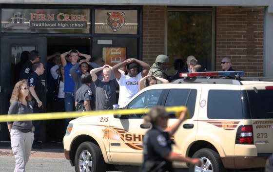Image: Students put their hands on their heads as they are lead out of Fern Creek High School in Louisville, Ky