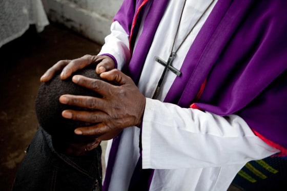 A child accused of sorcery is exorcised in DR Congo.
