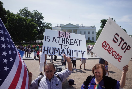 Demonstrators at a rally supporting Kurdistan hold placards protesting against the Islamic State of Iraq and Syria (ISIS) in front of the White House on August 16, 2014.