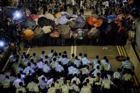Image: Police forces march toward pro-democracy protesters during a standoff outside the central government offices in Hong Kong