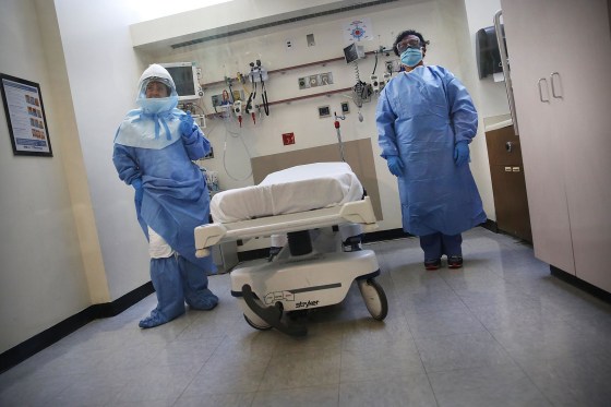 Members of the Bellevue Hospital staff wear protective clothing as they demonstrate how they would receive a suspected Ebola patient on Oct. 8 in New York City. 