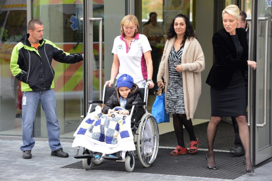 A medic wheels five-year-old Ashya King who suffers from brain tumor to an ambulance car on October 24, 2014 in Prague. Five-year-old British brain tumor patient Ashya King is feeling better after 30 sessions proton therapy in Prague and is now heading back to Spain, his doctor said. King's case made headlines after his parents removed him from a hospital in Britain in August 2014 against doctors' wishes, sparking an international manhunt. 