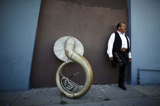 Image: Mariachi musician Moises Rivera waits for a gig in the Boyle Heights area of Los Angeles