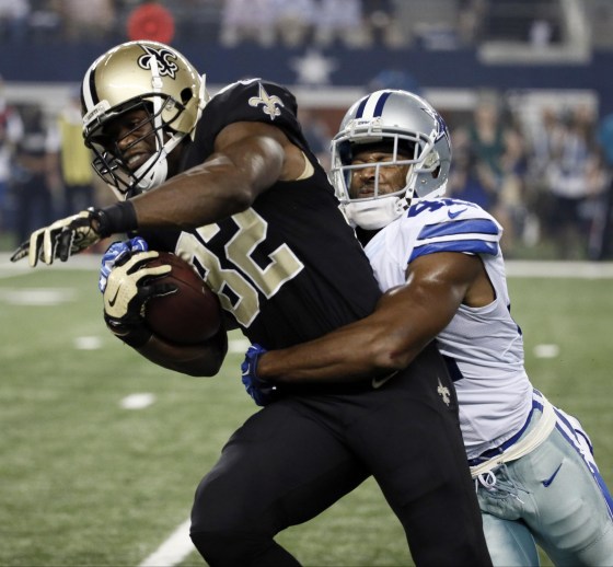 New Orleans Saints tight end Benjamin Watson (82) fights for extra yardage against Dallas Cowboys free safety Barry Church (42) during the first half of an NFL football game, Sunday, Sept. 28, 2014, in Arlington, Texas. (AP Photo/Brandon Wade)