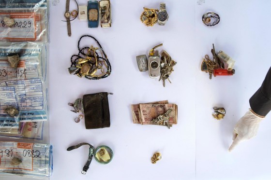 Personal possessions of 2004 tsunami victims are arranged to be photographed outside a police station in Takua Pa, in Phang Nga province December 19, 2014. Thai police opened a shipping container filled with documents and possessions of victims of the 2004 Indian Ocean Tsunami after being asked by Reuters for permission to film its contents. The three metre by 12 metre container was handed over to Thai police in 2011 and contains hundreds of plastic police evidence bags - each one holding the precious items found on the body of a victim. In Thailand, over 5,300 people were killed, including several thousand foreign tourists, when the waves swamped six coastal provinces, turning some of the world's most beautiful beaches into mass graves. REUTERS/Damir Sagolj (DISASTER ENVIRONMENT SOCIETY ANNIVERSARY TPX IMAGES OF THE DAY) ATTENTION EDITORS: PICTURE 6 OF 24 FOR WIDER IMAGE PACKAGE 'TSUNAMI - UNCLAIMED POSSESSIONS' SEARCH 'DAMIR UNCLAIMED' FOR ALL IMAGES