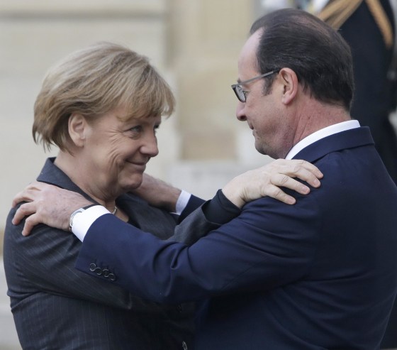 Image: French President Francois Hollande embraces German Chancellor Angela Merkel, left, as she arrives at the Elysee Palace, Paris, Sunday, Jan. 11, 2015