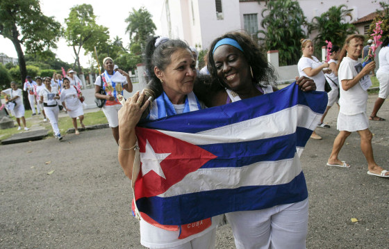 Recently released dissidents Aide Gallardo (L) and Sonia Garro hold the Cuban national flag during a march in Havana January 11, 2015. Cuba has released all 53 prisoners it had promised to free, senior U.S. officials said, a major step toward détente with Washington. The release of the remaining prisoners sets a positive tone for historic talks next week aimed at normalizing relations after decades of hostility, the officials said.