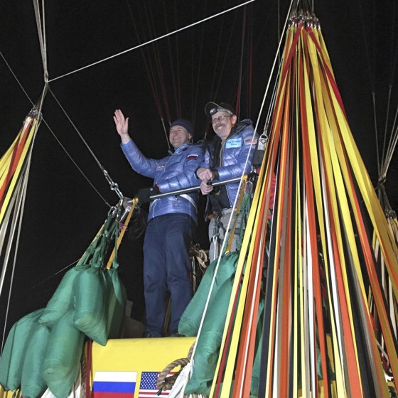 Image: Pilots Tiukhtyaev and Bradley greet spectators a few minutes before setting off on their attempt to cross the Pacific by balloon and set a new distance and duration record for gas balloon travel, in Saga