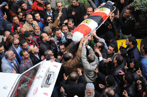 Image:Mourners carry the coffin of Shaima al-Sabbagh, an Egyptian protester who was killed in clashes with the police, during her funeral on January 25, 2015 in Egypt's second city Alexandria