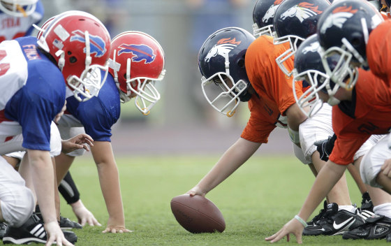 Image: Players line up during a 6th grade youth football game in Richardson, Texas