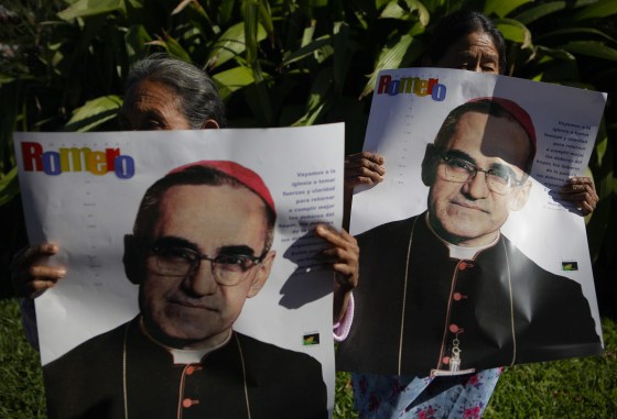 epa04531694 Victims of the armed conflict in El Salvador hold posters showing the image of late archbishop Oscar Arnulfo Romero, during a protest march in San Salvador, El Salvador, 16 December 2014. The protest is against the decision of the Mayor to name a street with the name of the deceased Army major Roberto D'Aubuisson, allegedly the mastermind of the killing in 1980 of Romero in San Salvador. EPA/Oscar Rivera