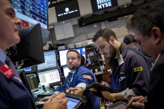 Image: Traders work on the floor of the New York Stock Exchange